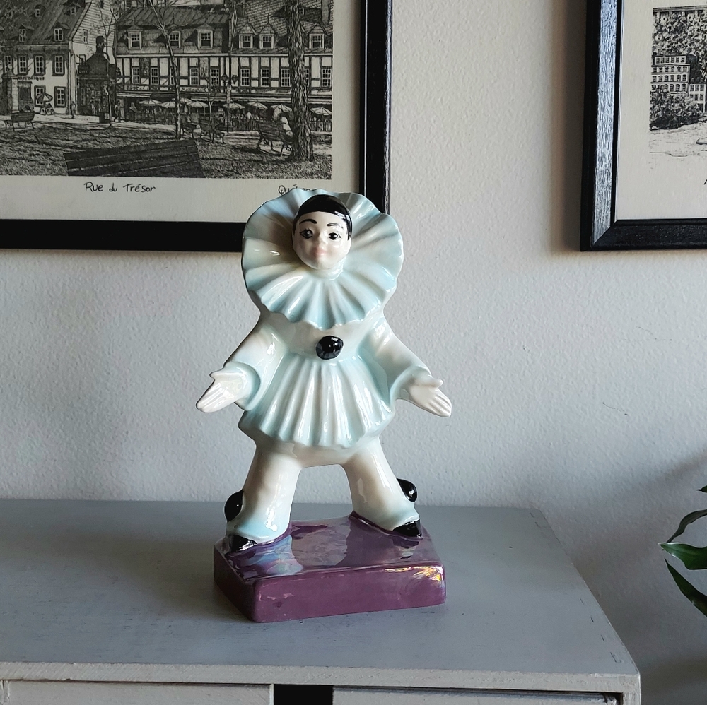 Pierrot Harlequin clown standing on a rectangular base.